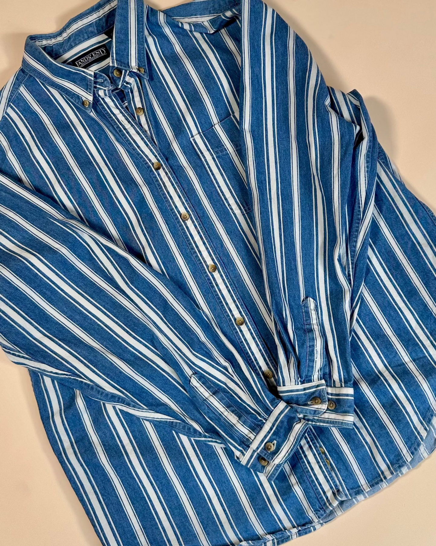 Blue and white striped shirt on a beige background