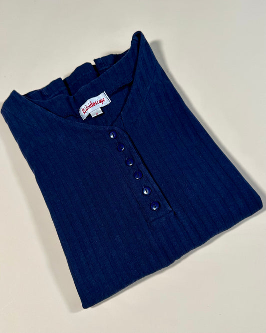 Folded blue shirt with a brand label on a white background